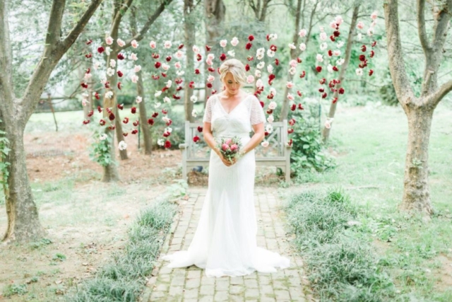 bride standing in front of beautiful floating flower display
